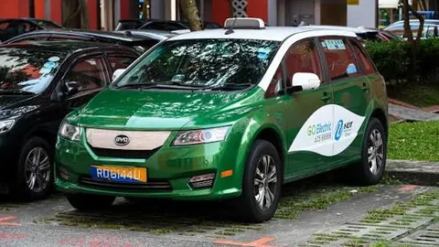HDT Electric Taxi, a green BYD electric vehicle with GO Electric branding