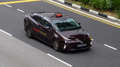 Strides Premier maroon Toyota Prius on the highway