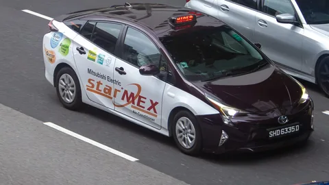 Strides Premier maroon Toyota Prius wrapped in a Mitsubishi Electric StarMEX ad